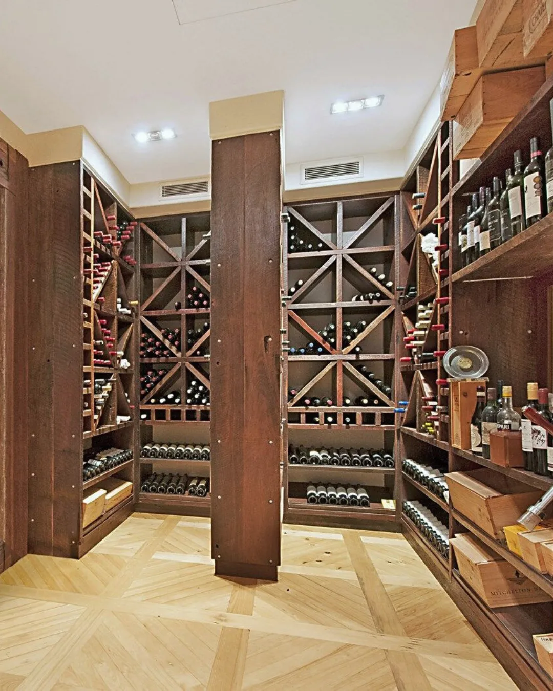 Walk-in wine cellar with timber racking and a parquet floor
